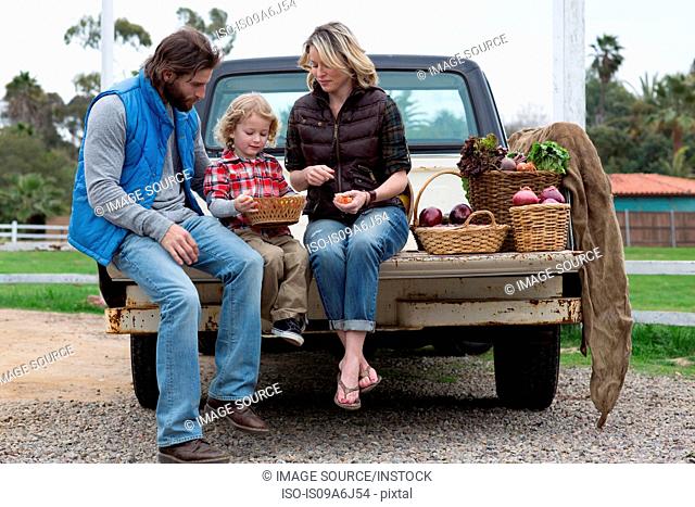 Family with produce in truck bed