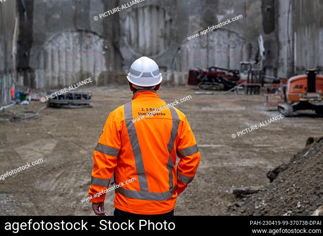 19 April 2023, Bavaria, Munich: A worker stands on the construction site of the second S-Bahn main line in Munich during a press tour