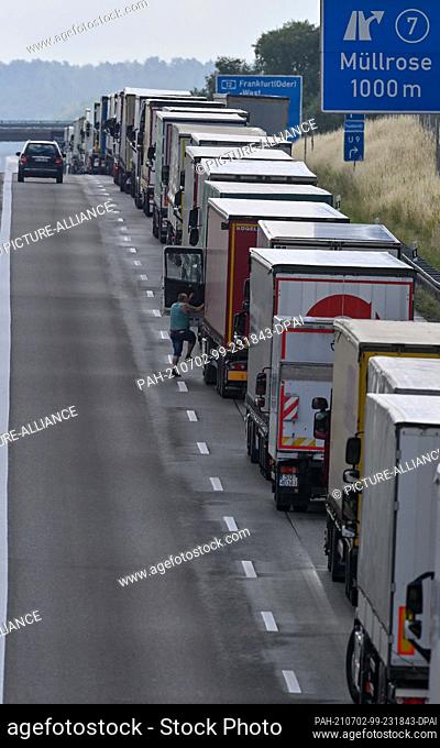 02 July 2021, Brandenburg, Jacobsdorf: Trucks are parked bumper to bumper on the eastbound A12 motorway about 15 kilometres from the German-Polish border...