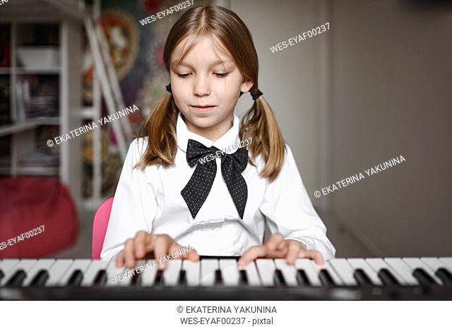 Portrait of a girl playing synthesizer