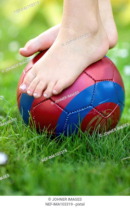 Childs feet on ball, close-up