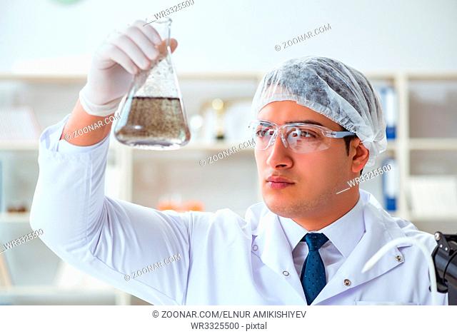 Young researcher scientist doing a water test contamination experiment in the laboratory