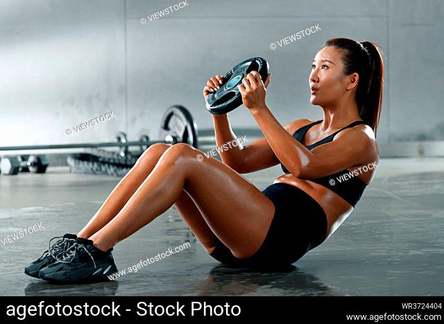Young women in the gym training