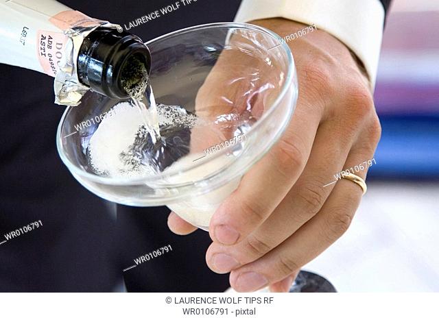 Wedding, pouring champagne on glass