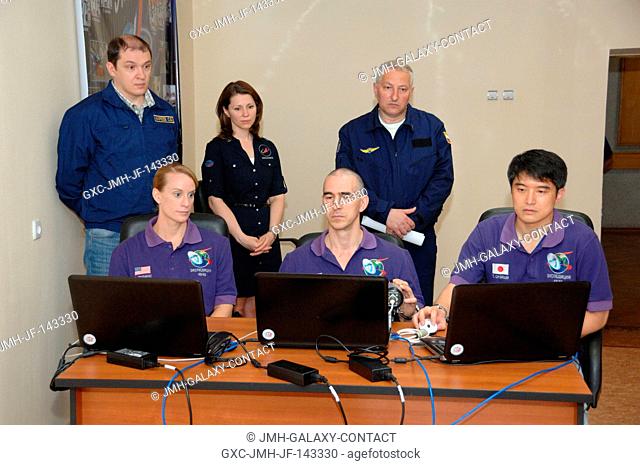 At the Cosmonaut Hotel in Baikonur, Kazakhstan, Expedition 48-49 crewmembers Kate Rubins of NASA (left), Anatoly Ivanishin of Roscosmos (center) and Takuya...