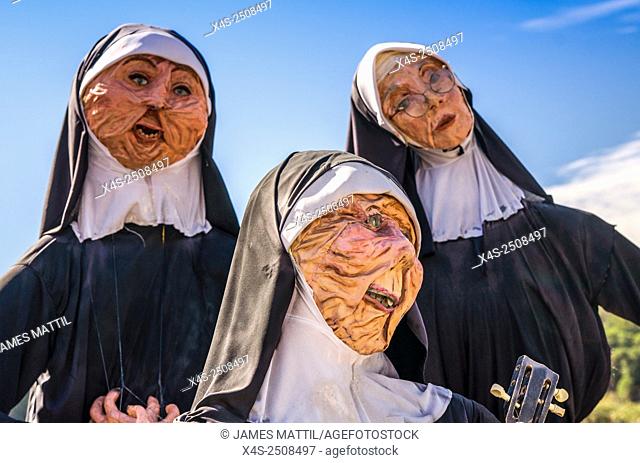 Homemade scarecrows depicting singing nuns at a small town Halloween festival