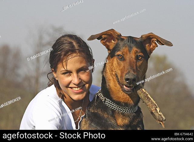 Young woman with Doberman-Sheepdog mixed-breed