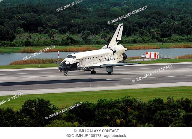 Space Shuttle Discovery slows to a stop after landing on runway 15 at Kennedy Space Center's Shuttle Landing Facility at 9:14 a.m