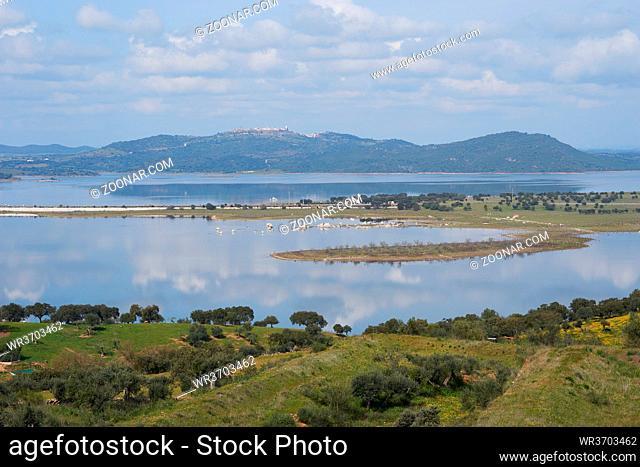 Lake reservoir water reflection of Alqueva Dam landscape and Monsaraz on the foreground in Alentejo, Portugal
