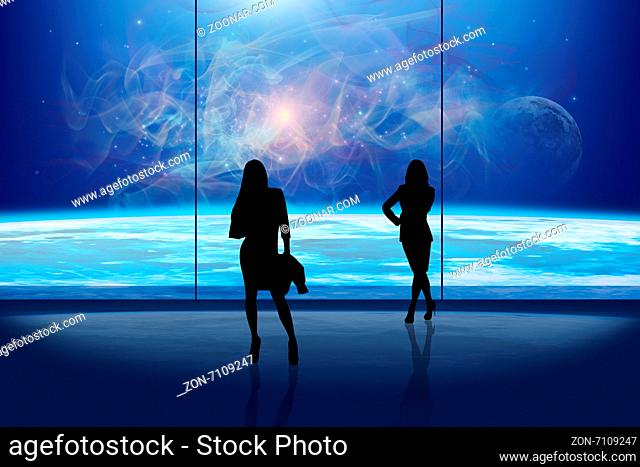 Business ladies in front of the window at night