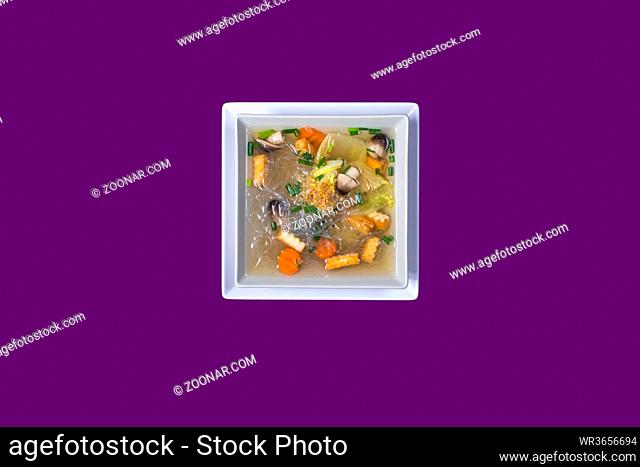 Tom seed tofu. Asian Thai food on white plates with purple background with copy space