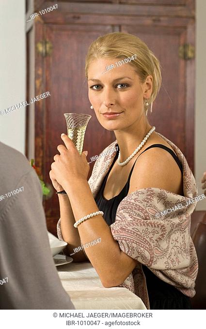 Festively dressed lady during a formal dinner in a solemn atmosphere