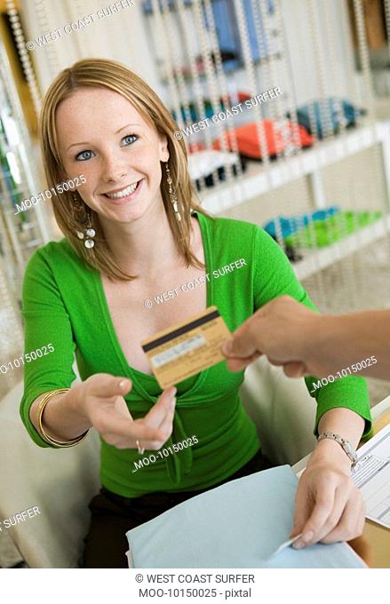 Young woman Paying for Clothes with Credit Card