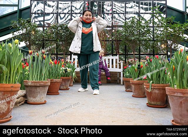 RUSSIA, MOSCOW - FEBRUARY 11, 2023: A woman at the Spring Rehearsal flower show in the Botanical Garden of Lomonosov Moscow State University (Apothecary Garden)...