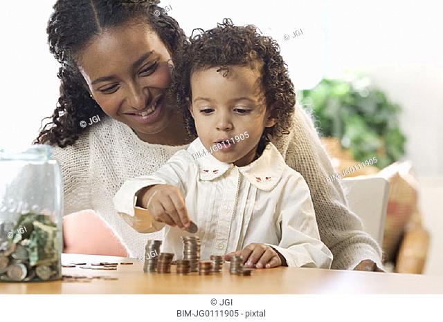 Mother and daughter counting coins