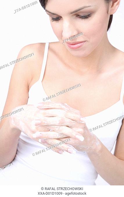 woman putting cream on hands