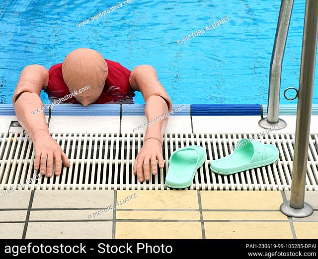 14 June 2023, Berlin: A special mannequin lies in the pool at the Humboldthain summer pool during the pre-swim of potential lifeguards