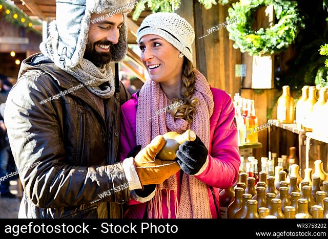 Man and woman buying vases as gift on traditional Christmas market