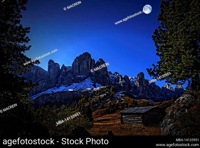 hut in the dolomites at night in the moonlight, south tyrol, italy
