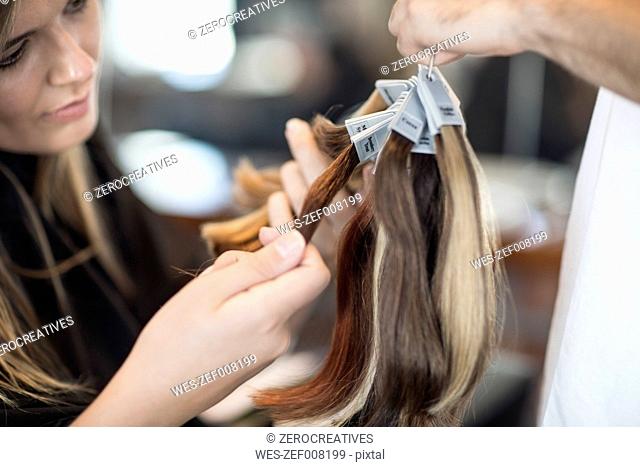 Woman in hair salon chooing new hair color