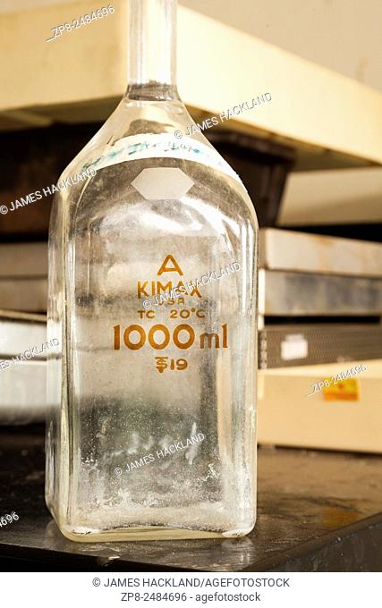 A dirty vintage volumetric flask used to measure 1000ml (1L) of liquid