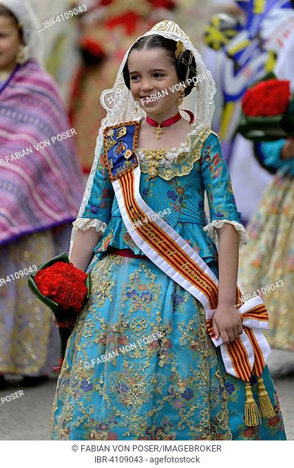 Fallas festival, girl in a traditional costume during the parade in the Plaza de la Virgen de los Desamparados, Valencia, Spain