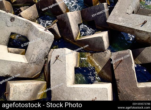 Breakwater blocks in the port. Breakwater of the rectangular stone figures