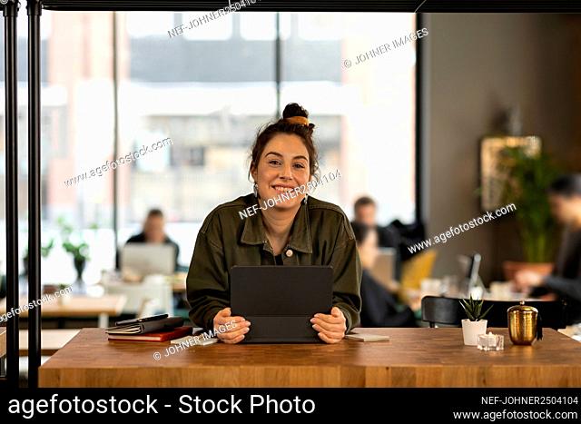 Woman in cafe looking at camera