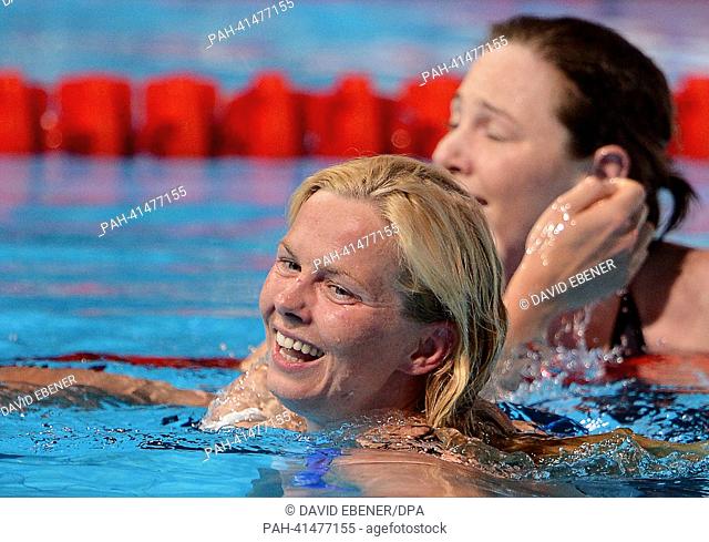 Britta Steffen of Germany (L) smiles next to gold medalist Cate Campbell of Australia after the women's 100m Freestyle final during the 15th FINA Swimming World...
