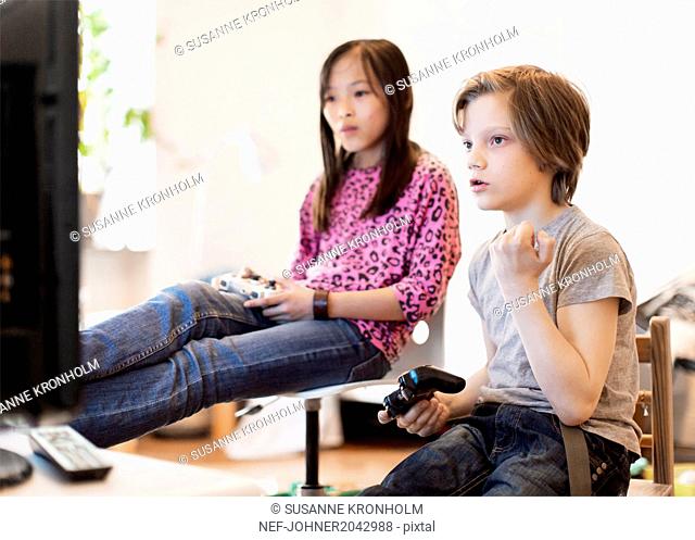 Boy and girl playing video game