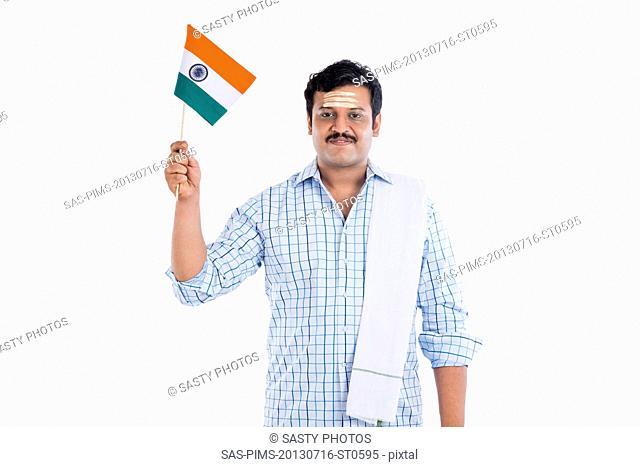 Portrait of a South Indian man holding national flag of India