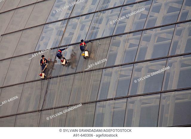 Men at work cleaning the glass roof, new opera house near Tian Nen Men square , opening 2008 (Architect Paul Andreu from France). City of Beijing