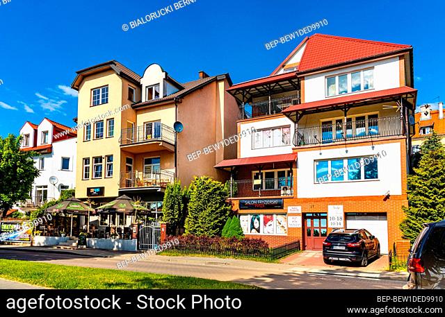 Elk, Poland - June 2, 2021: Panoramic view of lake promenade ulica Pulaskiego street with tourist pensions and restaurants along Jezioro Elckie lake shore in...