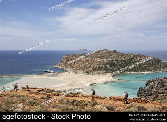 12 May 2022, Greece, Kissamos: Tourists walk along a path leading to Balos beach in the northeastern part of the island of Crete