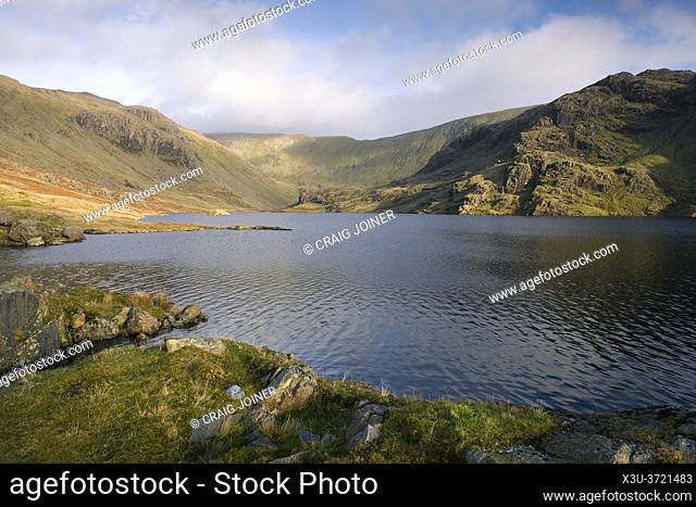 The dam of Seathwaite Tarn reservoir with Swirl How beyond in the Lake District National Park, Cumbria, England
