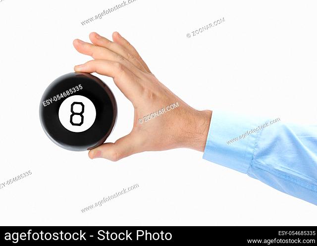 Hand with magic billiard ball number eight isolated on white background