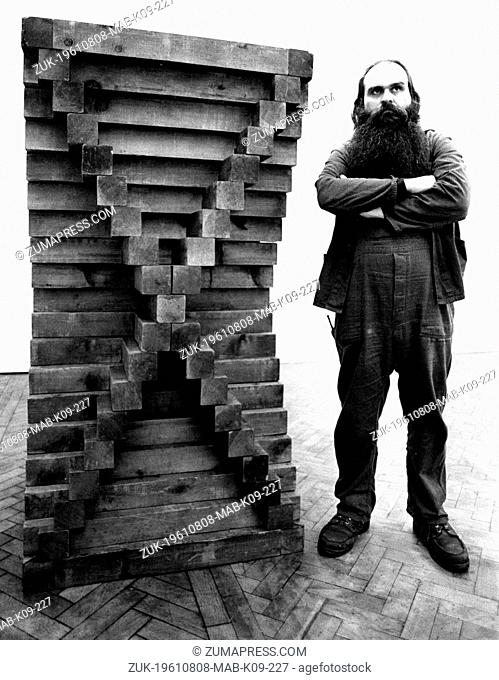 Aug. 8, 1961 - London, England, U.K. - The American sculptor and minimalist artist, CARL ANDRE, proudly displays his latest creation entitled 'Cedar Piece' at...