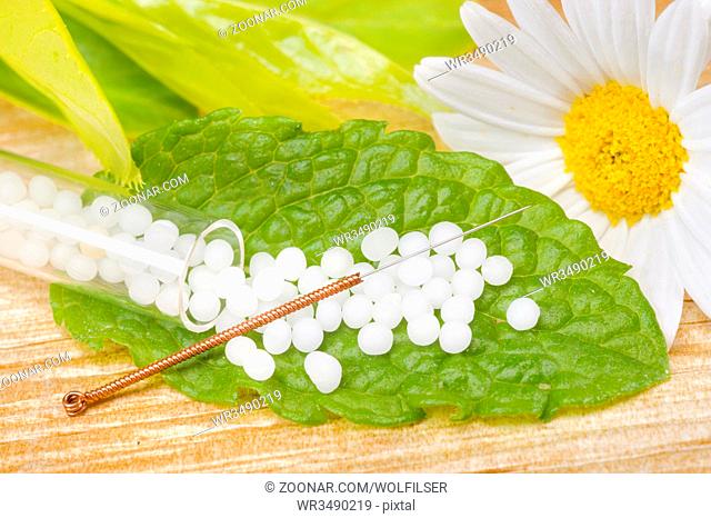 alternative medicine with herbal pills and acupuncture