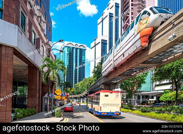 Streetscape of traffic, bridge and train in the Bukit Bintang district of Kuala Lumpur. The trains of the KL Monorail Line connects several stations inner city