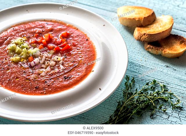 Portion of gazpacho on the wooden table