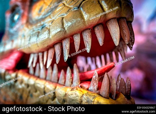 Open mouth showing sharp teeth of a Velociraptor dinosaur statue