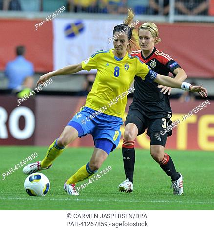Saskia Bartusiak (r) of Germany fights for the ball with Lotta Schelin of Sweden during the UEFA Women's EURO 2013 semi-final soccer match between Germany and...