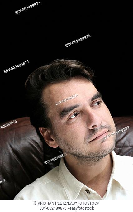 Young man pensive with black space above