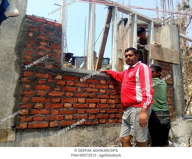 Teacher Dangal, who survived the earthquake in Nepal in 2015 in front of the re-building of his house in Irkhu, Nepal, 11 April 2017