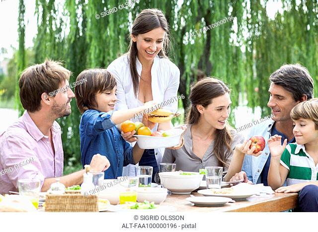 Family eating healthy meal together outdoors