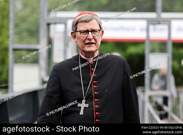 31 May 2022, North Rhine-Westphalia, Cologne: The Archbishop of Cologne, Cardinal Rainer Maria Woelki, walks across the pier to an excursion boat