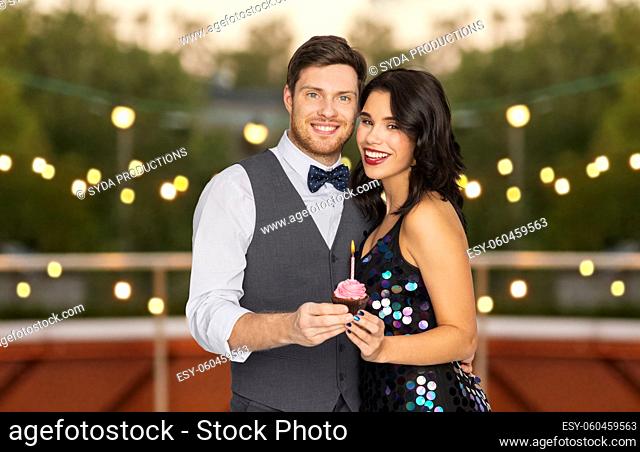 happy couple with cupcake at birthday party