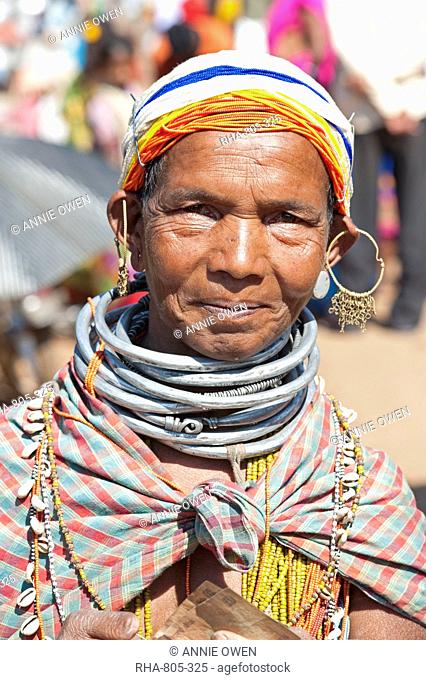 Smiling Bonda tribeswoman wearing cotton shawl over traditional bead costume, beaded cap, large earrings and metal necklaces, Rayagader, Orissa, India, Asia
