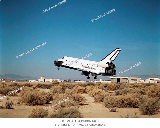 With its main landing gear not quite on the runway, the Space Shuttle Endeavour wraps up an eleven-day mission at Edwards Air Force Base, California