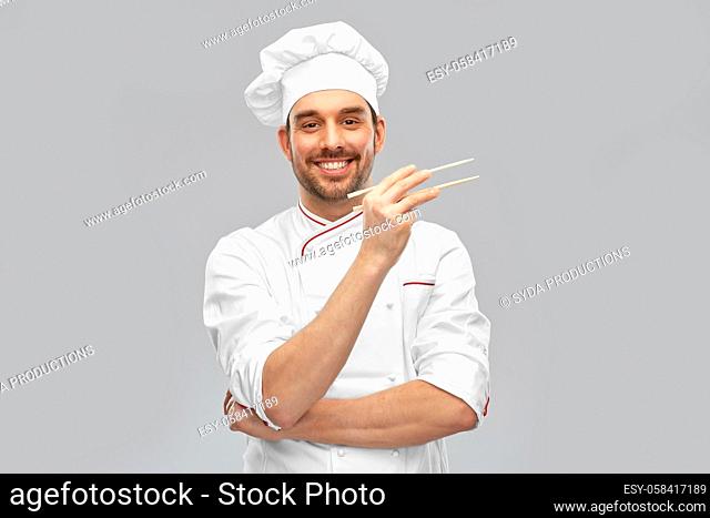 happy smiling male chef with chopsticks